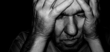 hombre mayor manos cabeza