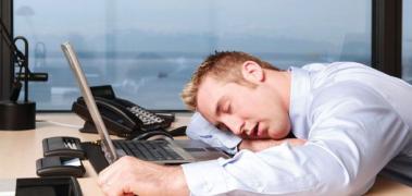man asleep on desk